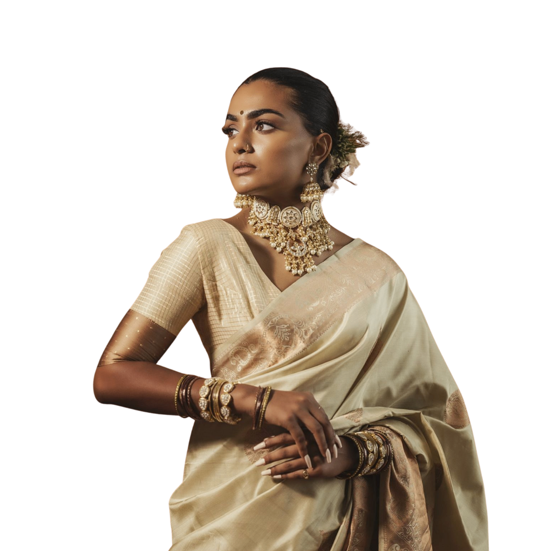 Woman in an ivory silk saree adorned with kundan jewellery
