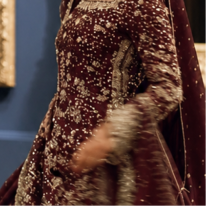 Detail of an embroidered maroon bridal outfit