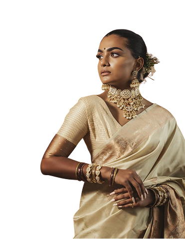 Stylist in a cream silk saree with gold jewellery